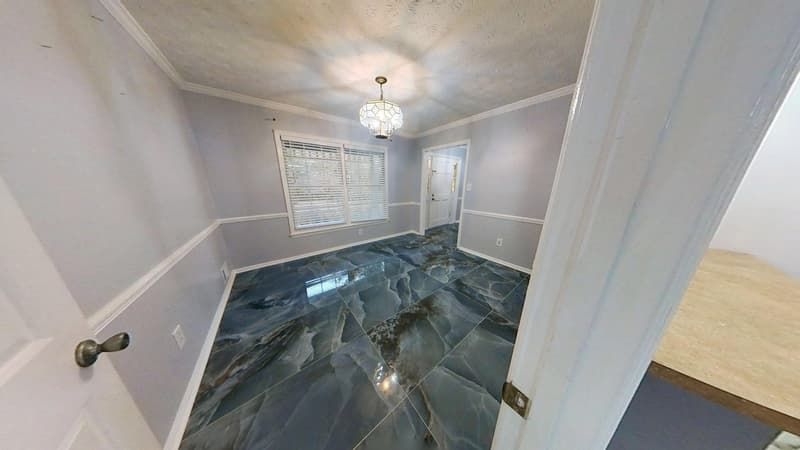 Dining room after fire restoration with new dark marble tile flooring and fresh painted walls