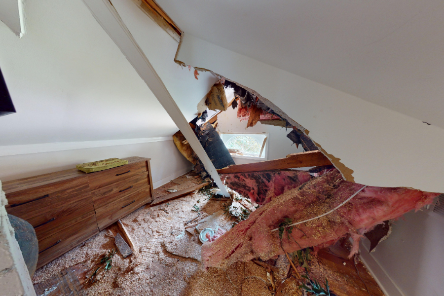 Ceiling damage from storm-related water intrusion requiring professional restoration
