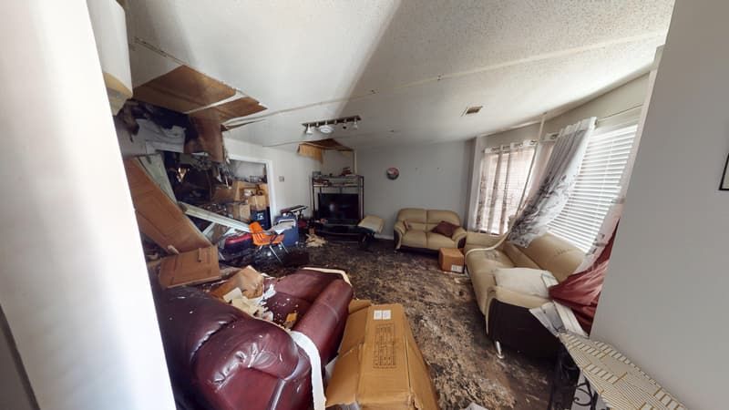 Family room showing extensive fire and smoke damage before remediation