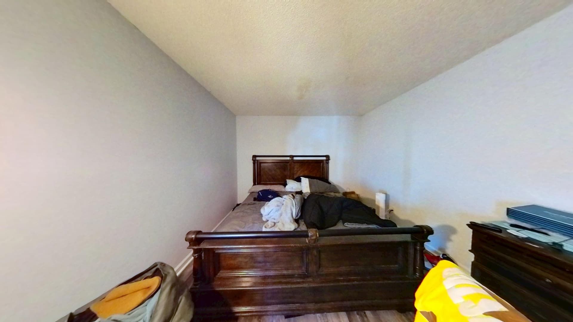 Fully restored bedroom with new paint and flooring after water damage repair