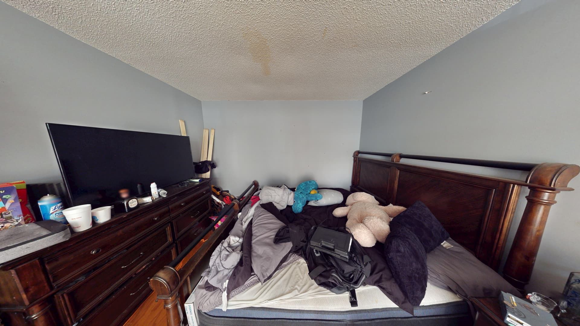 Bedroom with water-damaged flooring and walls before restoration in Lithonia
