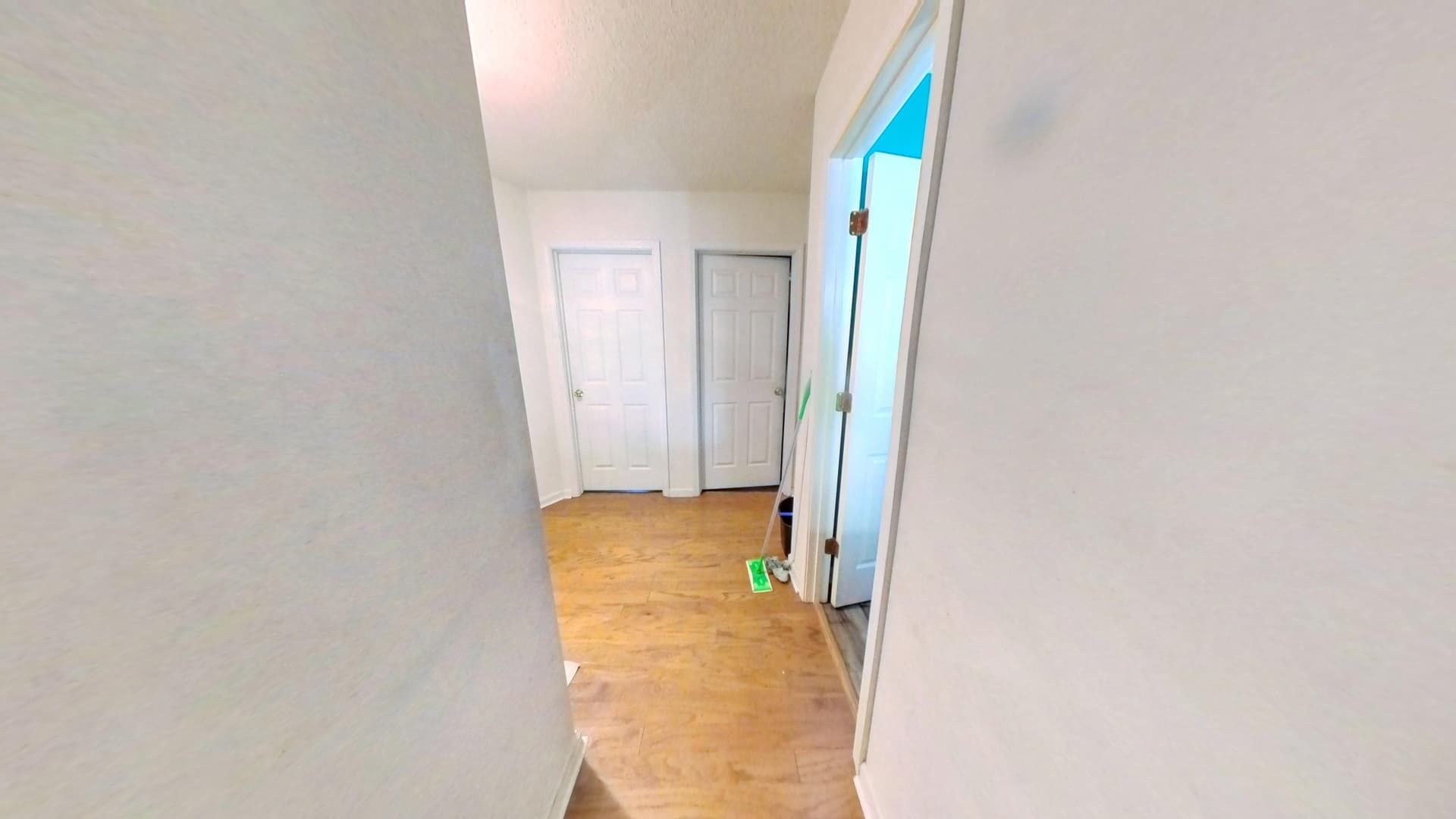 Fully restored hallway with new flooring and fresh paint in Lithonia home