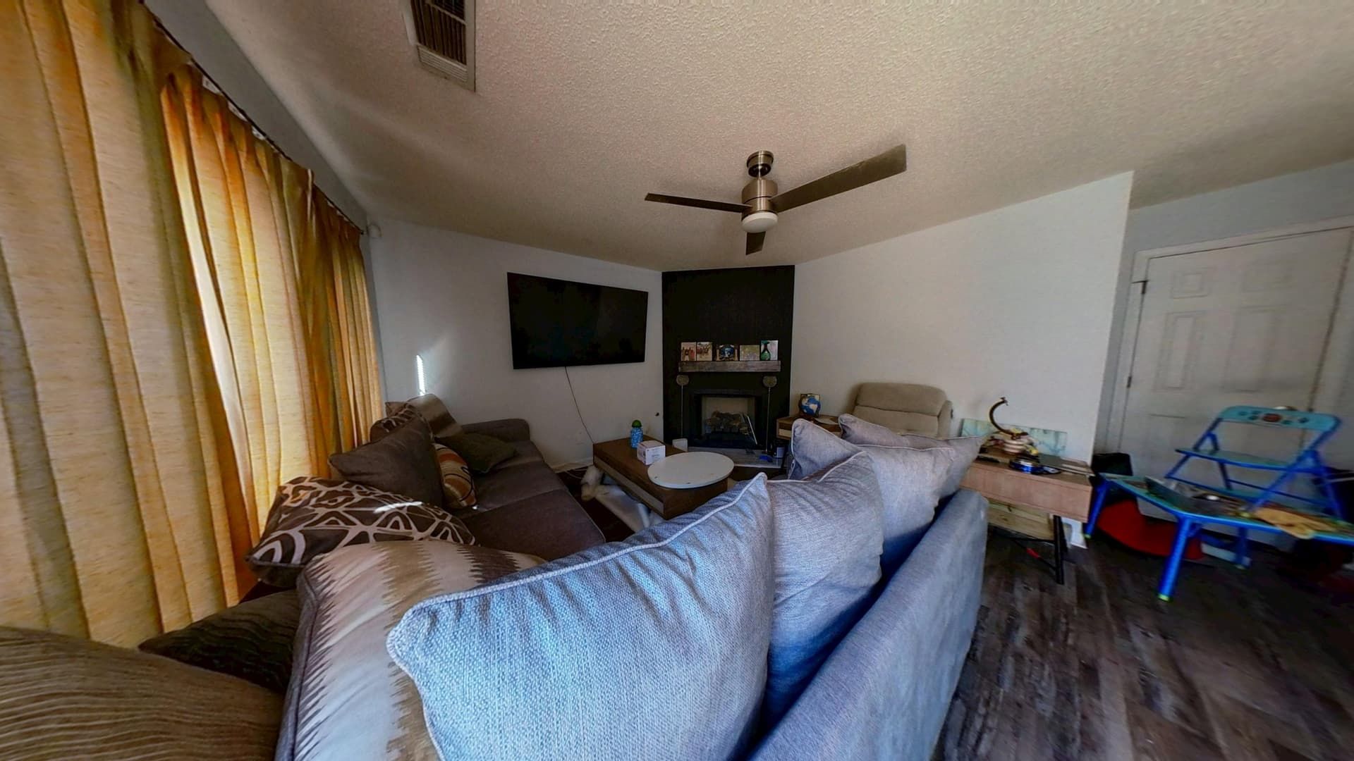 Restored living room with new carpet, fresh paint, and new baseboards
