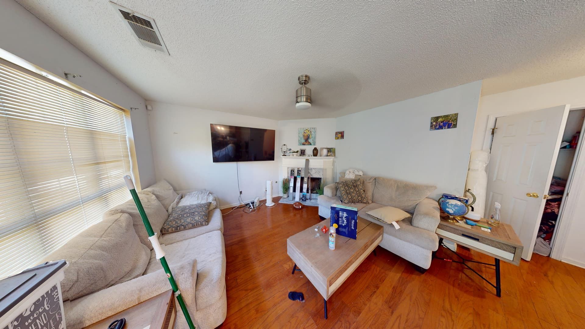 Living room with water-damaged carpet and baseboards before restoration