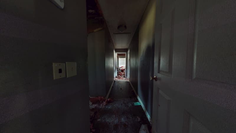 Hallway before fire damage restoration showing scorch marks and smoke staining