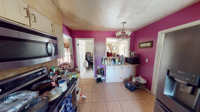 Third kitchen angle before restoration showing fire and smoke damage on walls and ceiling