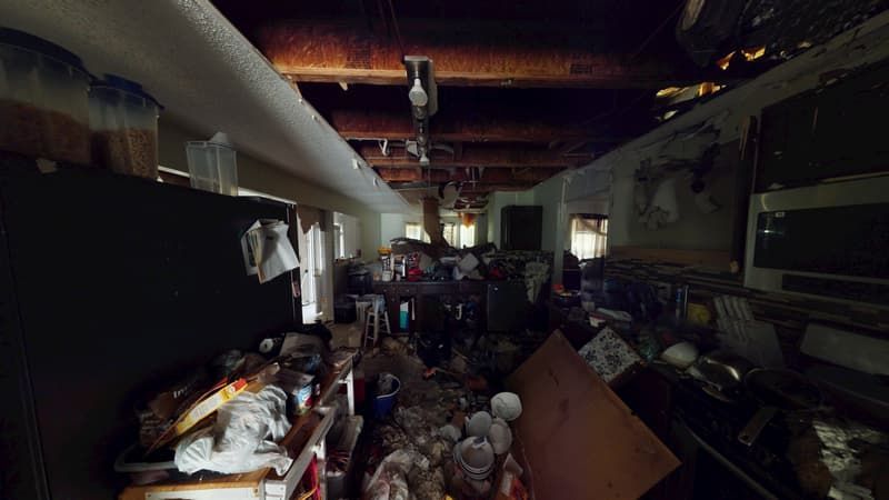 Kitchen with severe fire damage before demo and structure cleaning