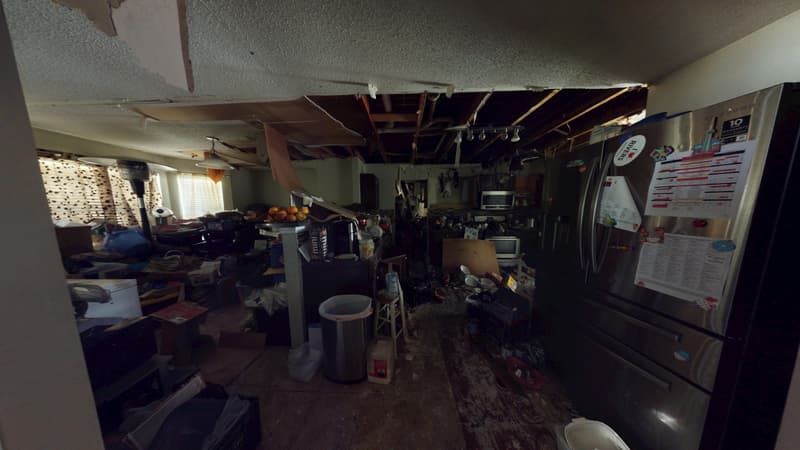 Fourth kitchen angle showing extensive fire and smoke damage before cleanup