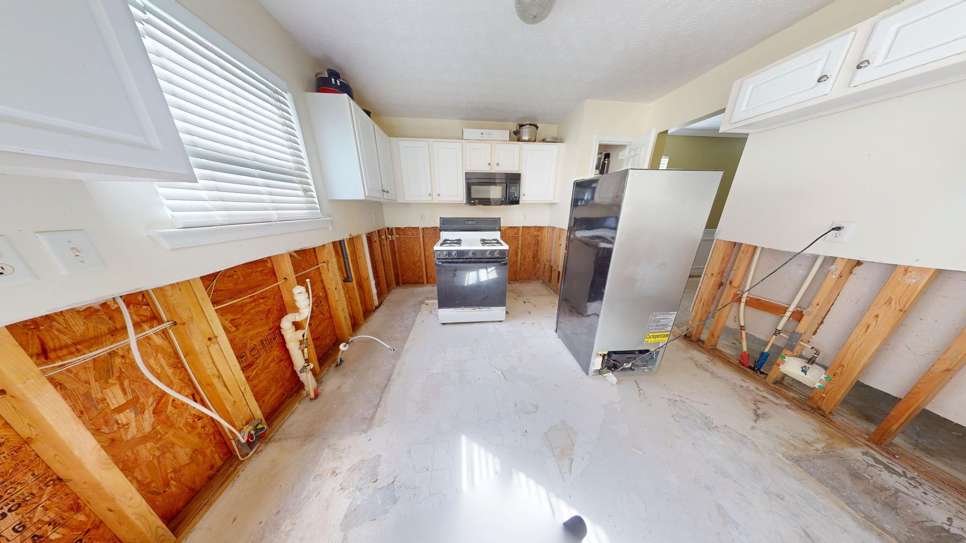 Kitchen water damage before restoration