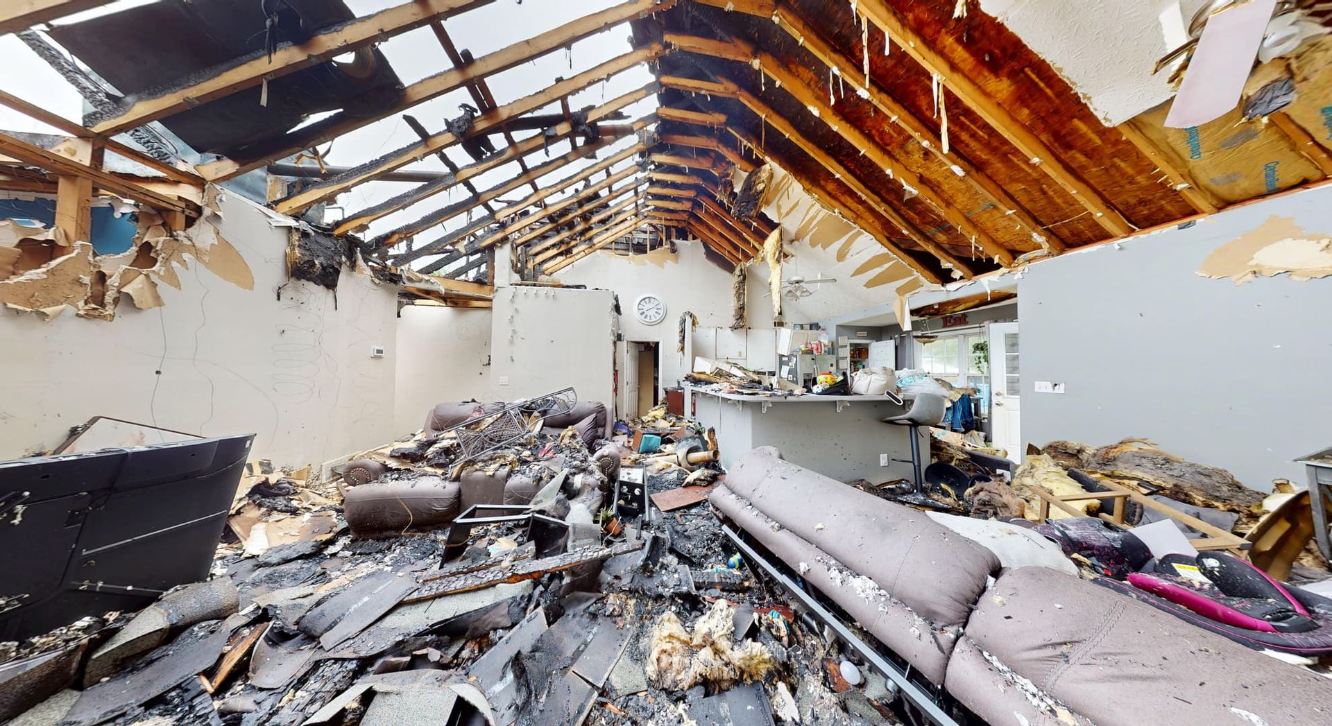 Smoke and soot damaged living room and dining room before fire restoration in Loganville home