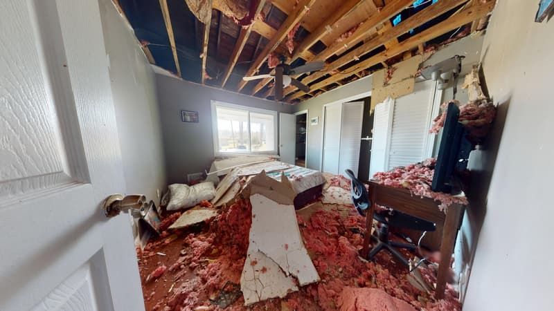 Second bedroom before fire restoration with visible charring and extensive smoke damage