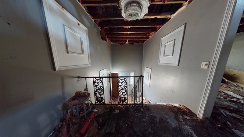 Upstairs area before fire damage restoration showing charred walls and smoke damage