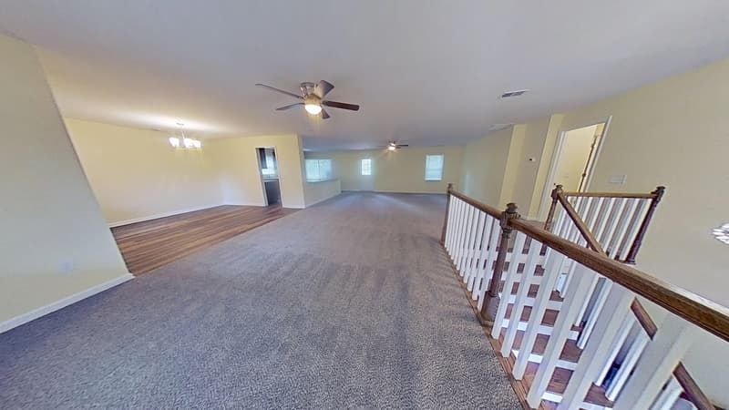 Upstairs living room fully restored after fire damage with clean walls and recovered space