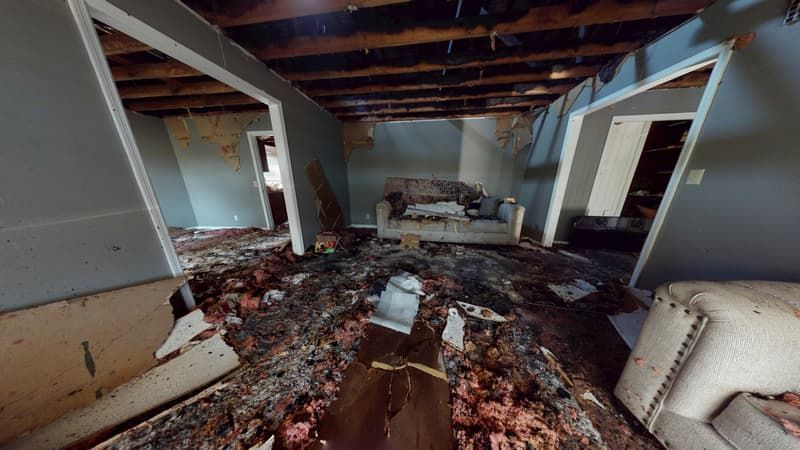 Upstairs living room before fire restoration showing heavy smoke staining and burned surfaces