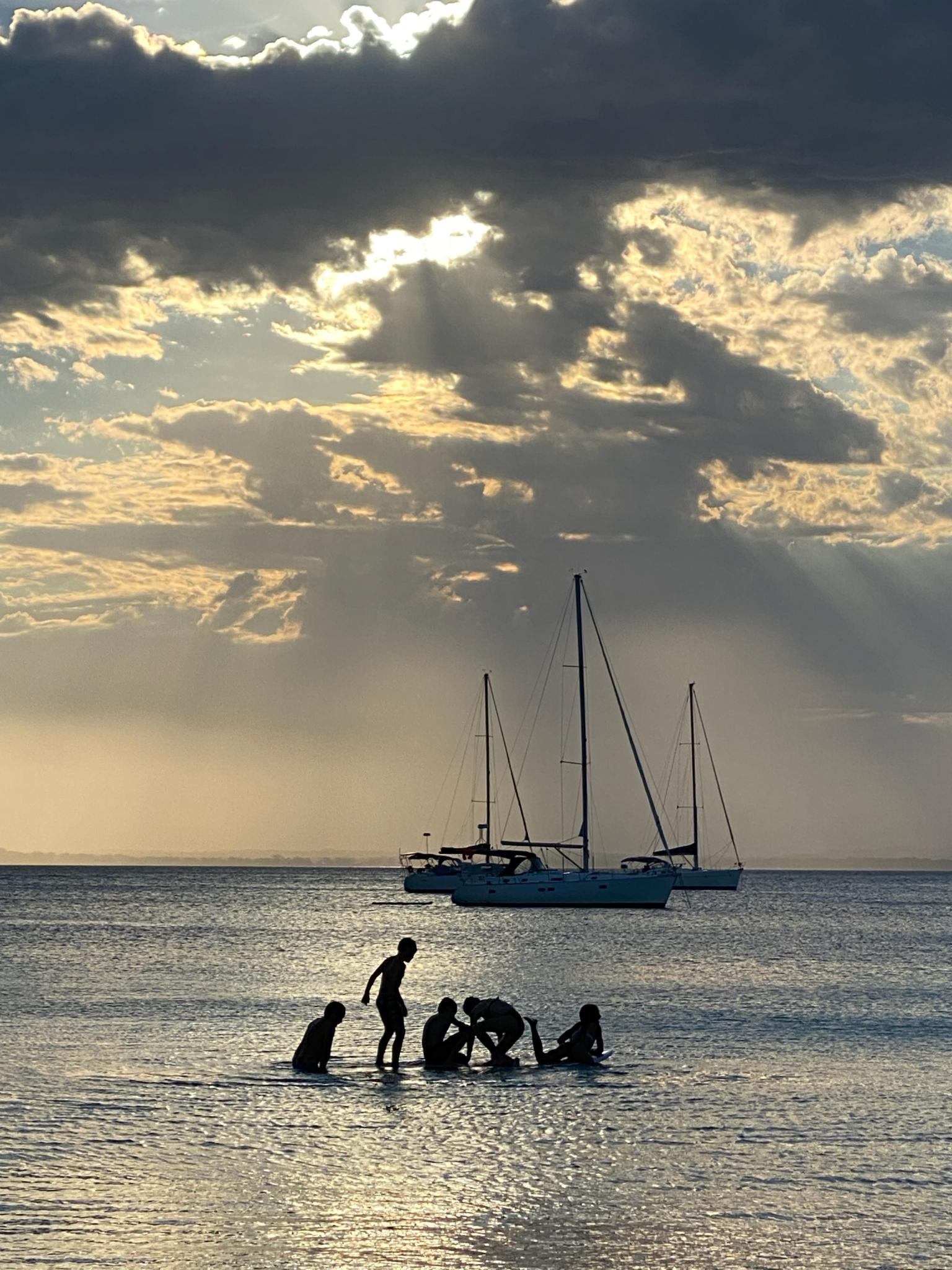 A group of people are playing in the water Currarong Beach NSW.