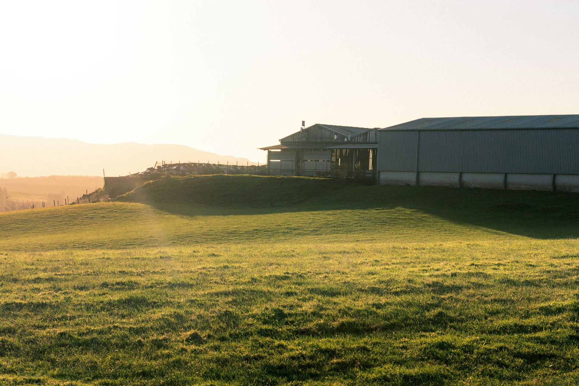 Rural Stirling property at sunset with large outbuilding in background