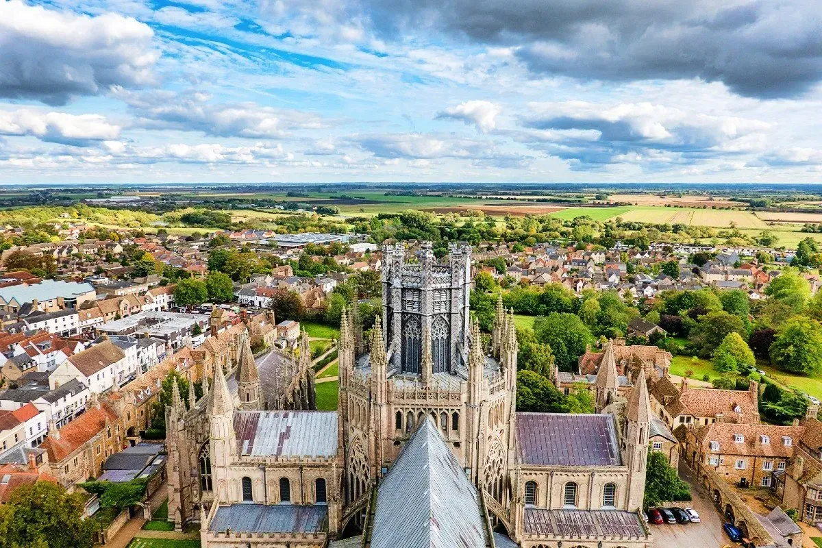 Black flat roof over white framed windows, under a brown tiled roof, with white gutter.