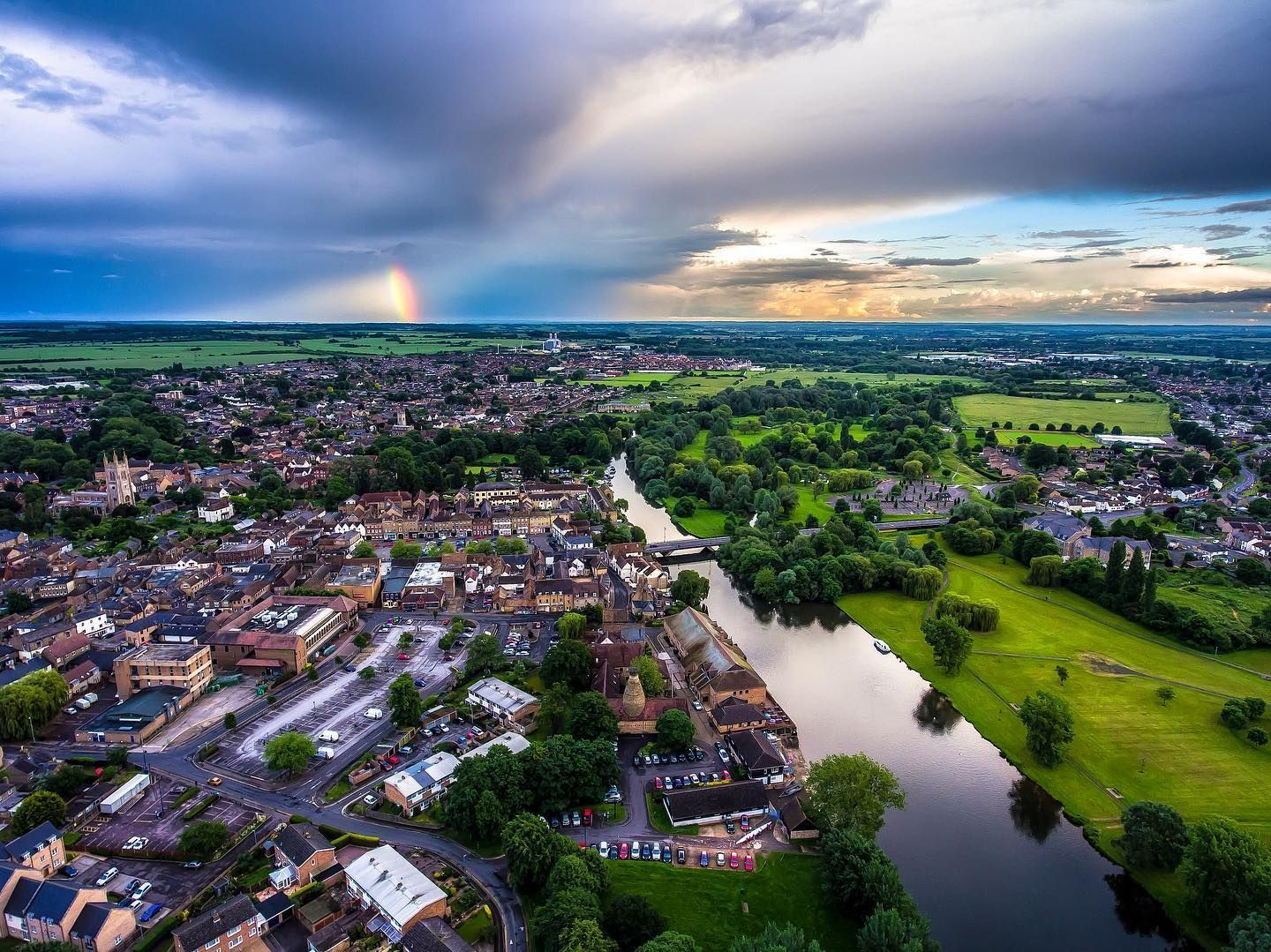 Black flat roof over white framed windows, under a brown tiled roof, with white gutter.