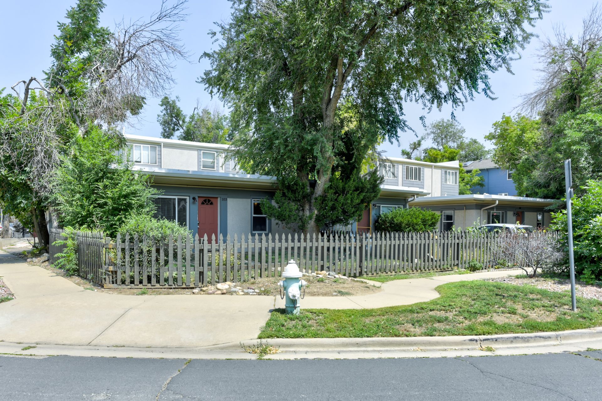 Aerial view of a town with a river running through it, under an overcast sky.