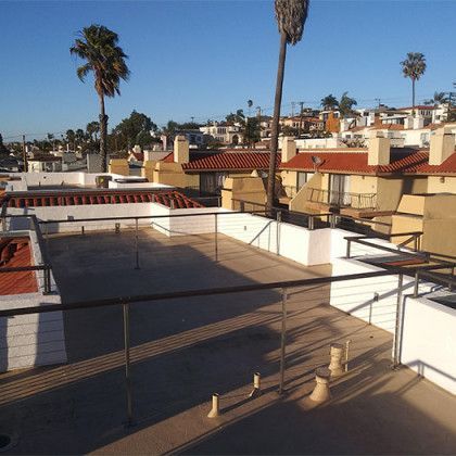 A balcony overlooking a city with palm trees