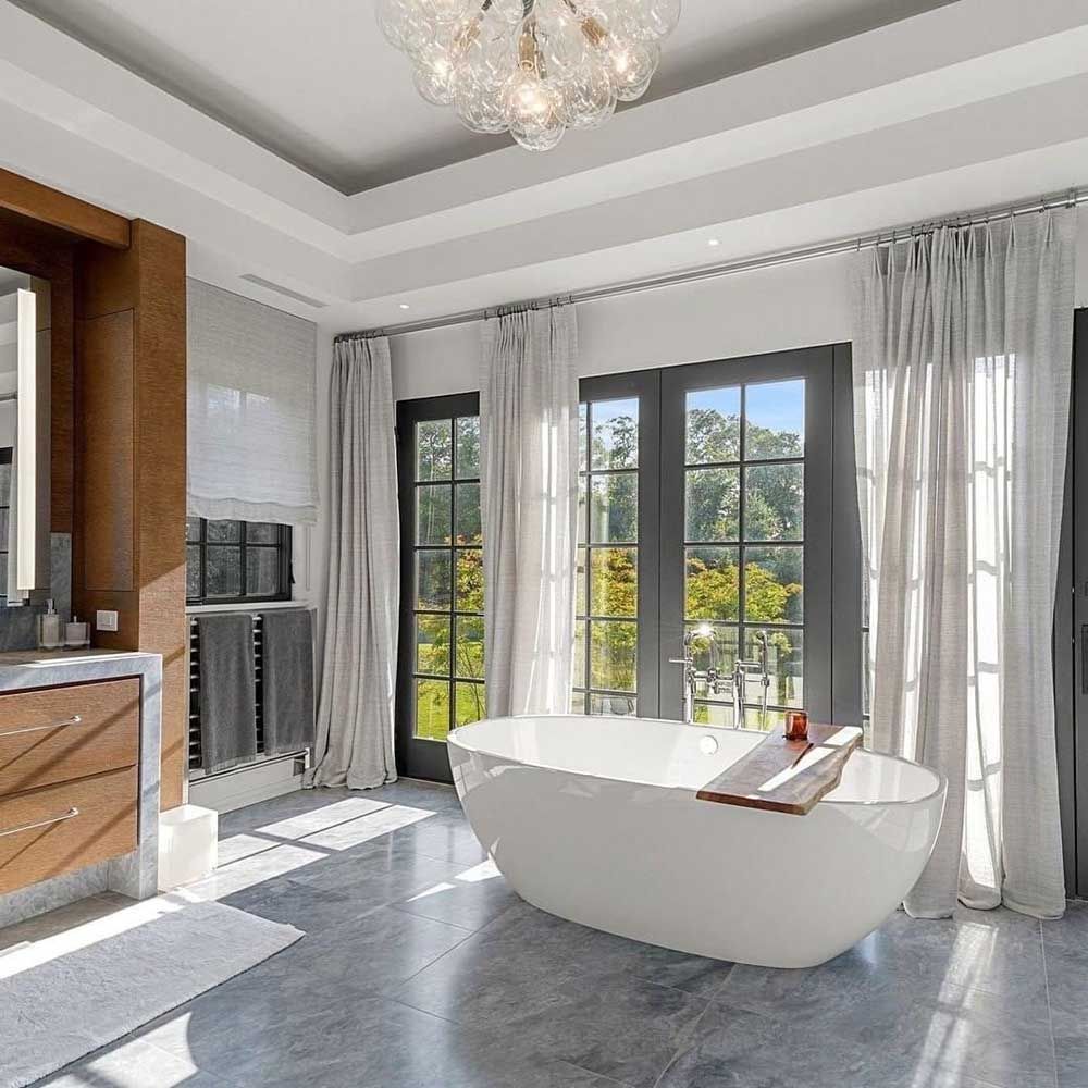 A bathroom with a large tub and a large window