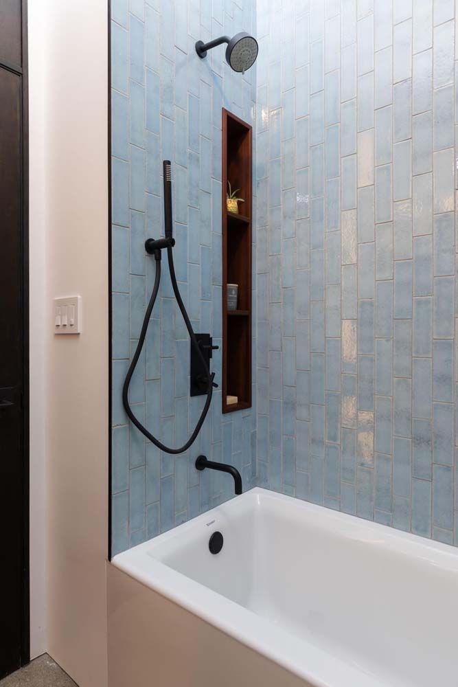 A bathroom with a bathtub and a shower.