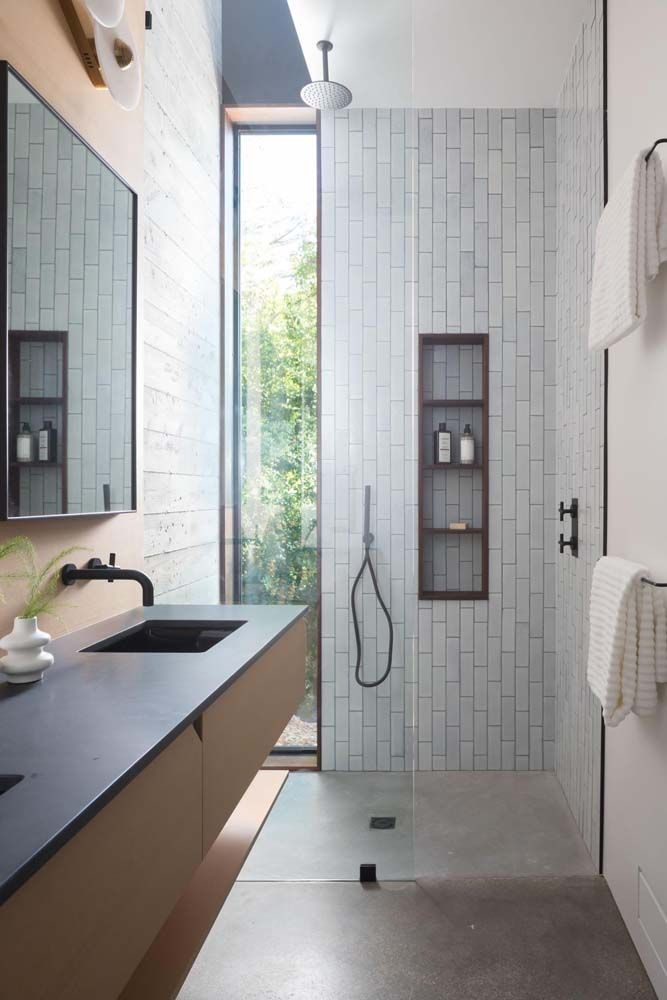 A bathroom with a sink and a walk in shower