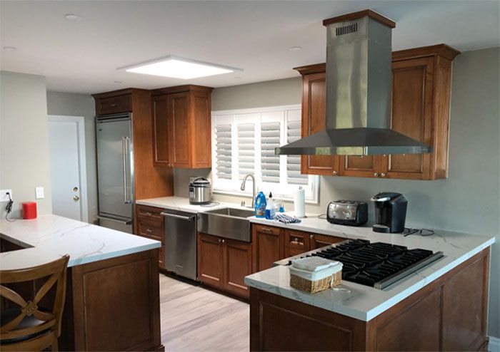 A kitchen with wooden cabinets and stainless steel appliances.