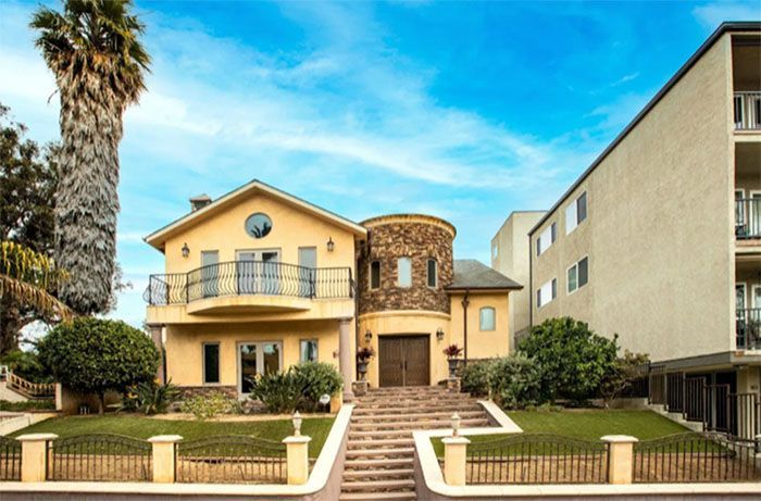A large house with stairs leading up to it
