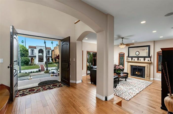 A living room with hardwood floors and a fireplace.