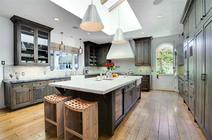 There is a large island in the middle of the kitchen.