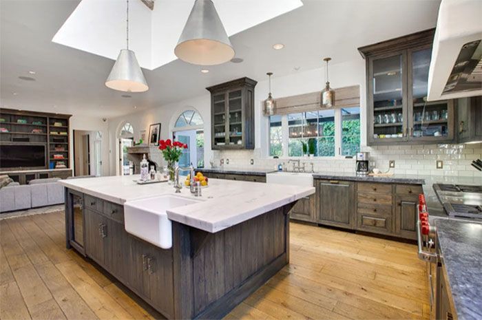 A large kitchen with a large island and a sink.