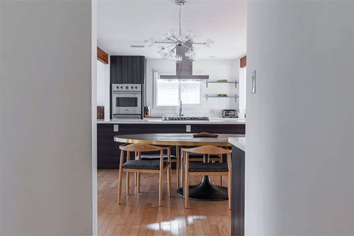 A kitchen with a table and chairs in it