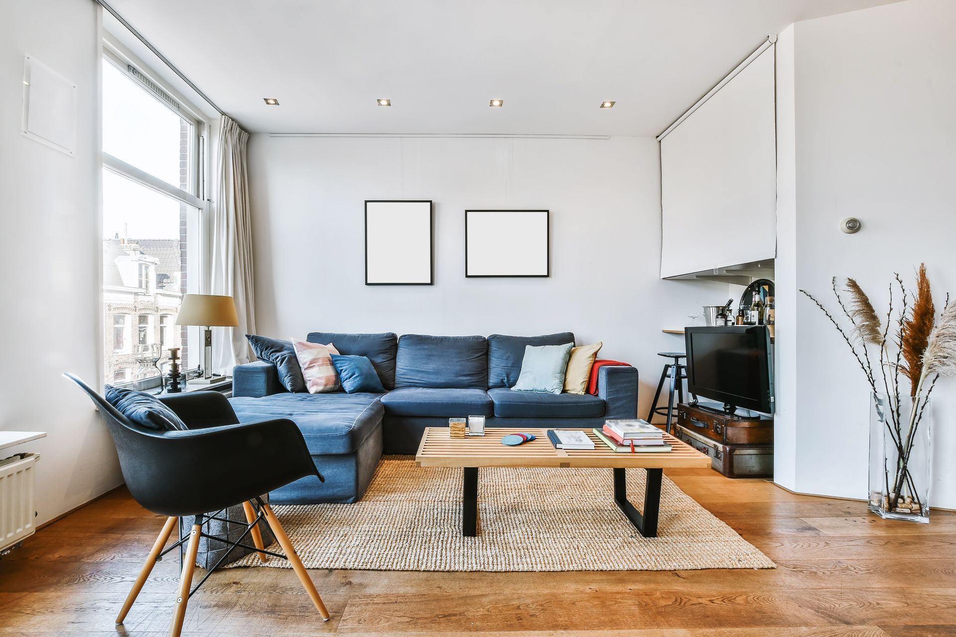 A living room with a couch , chair , coffee table and television.