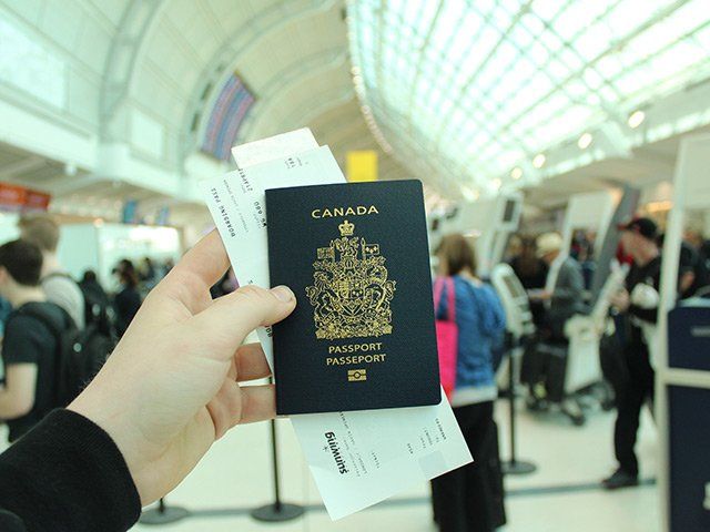 Hand holding canadian passport