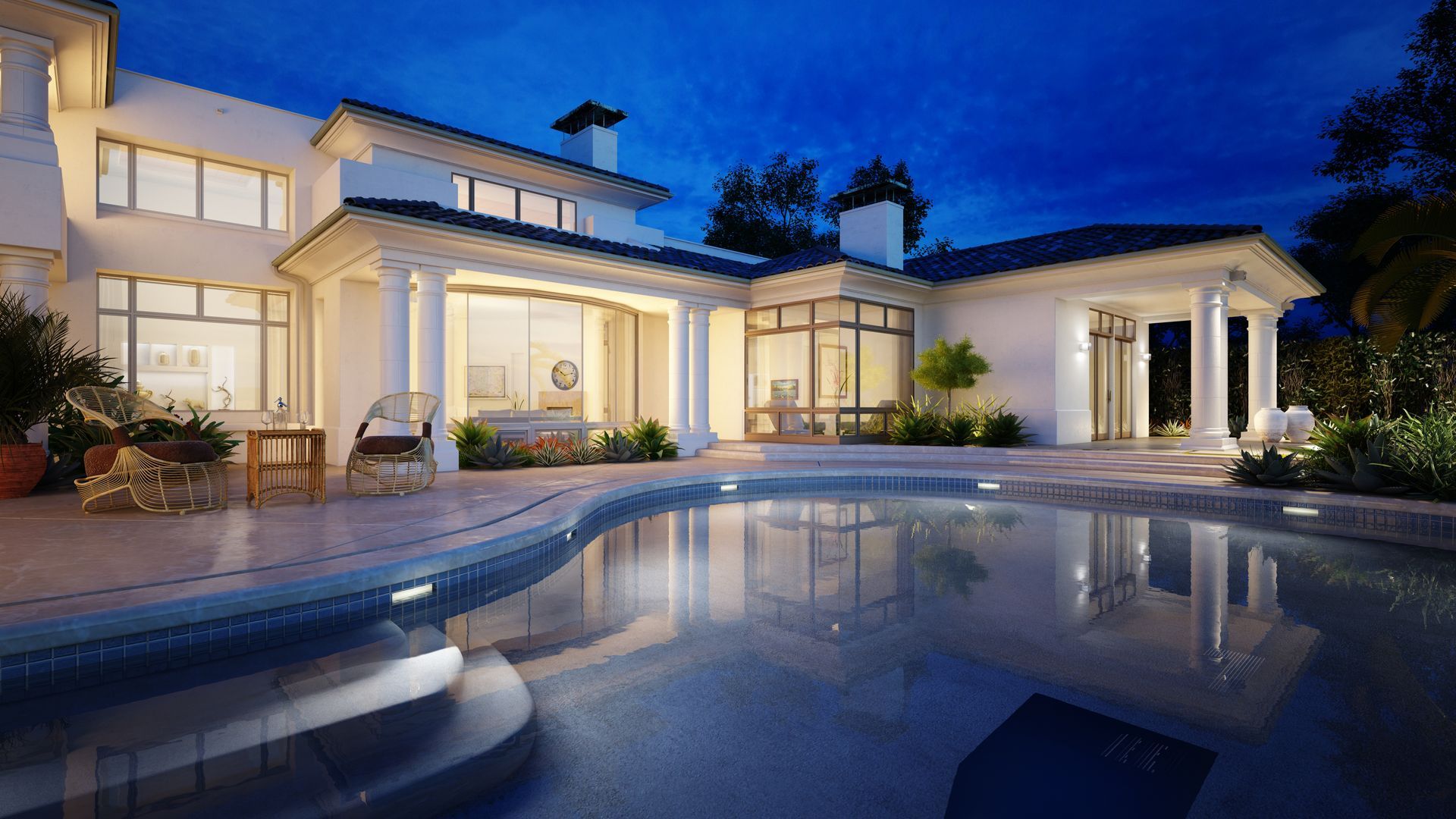 Elegant white mansion at night with pool reflecting the house and a deep blue sky.