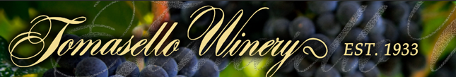 Tomasello Winery logo with elegant gold text over a blurred background of dark purple wine grapes, established 1933.