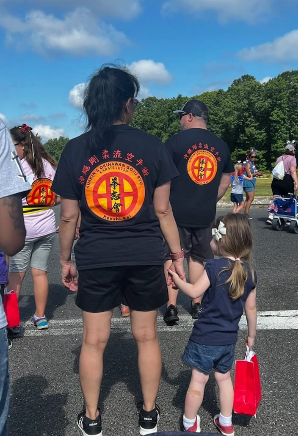 A group of people wearing black shirts with chinese writing on them