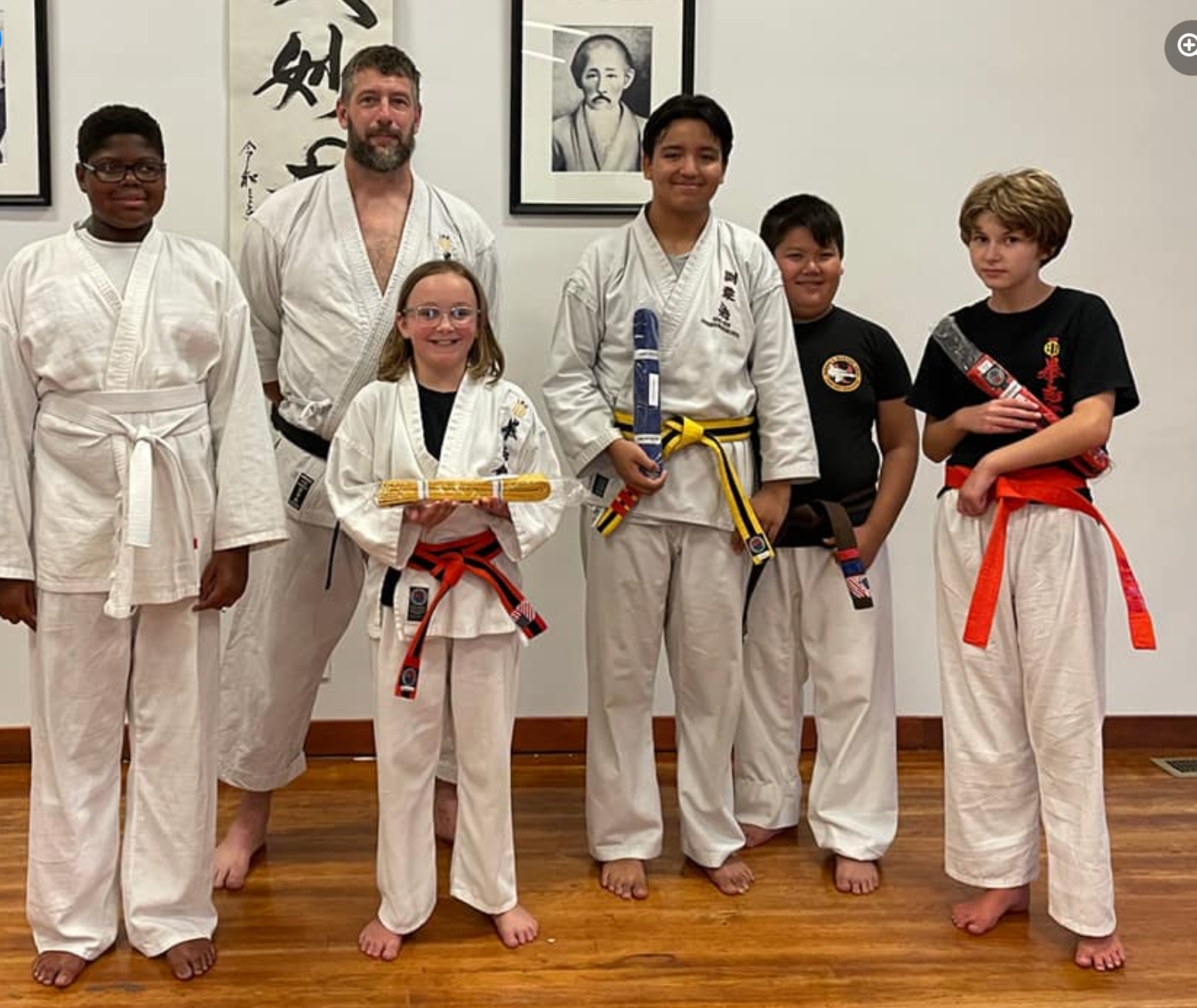 a group of martial arts students pose for a picture