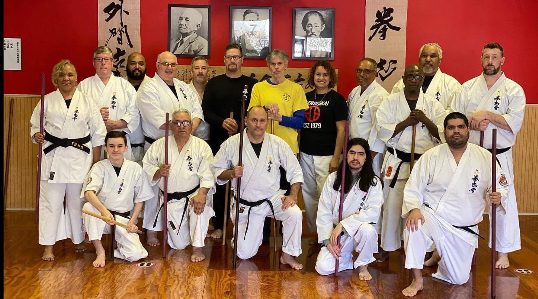 A group of people in karate uniforms are posing for a picture