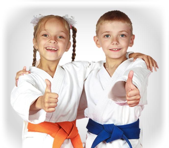a boy and a girl in karate uniforms give a thumbs up