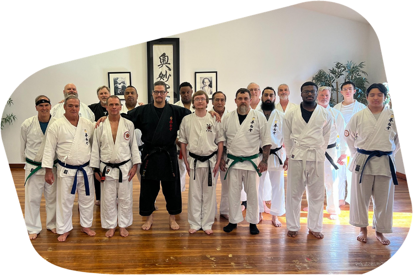 a group of men in karate uniforms pose for a picture