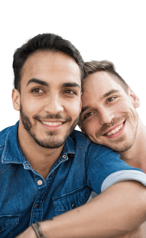 Two smiling people in a close embrace.