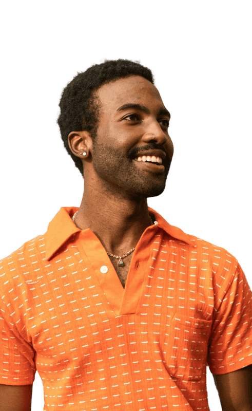 Man in orange polo shirt smiles, looking to the side.