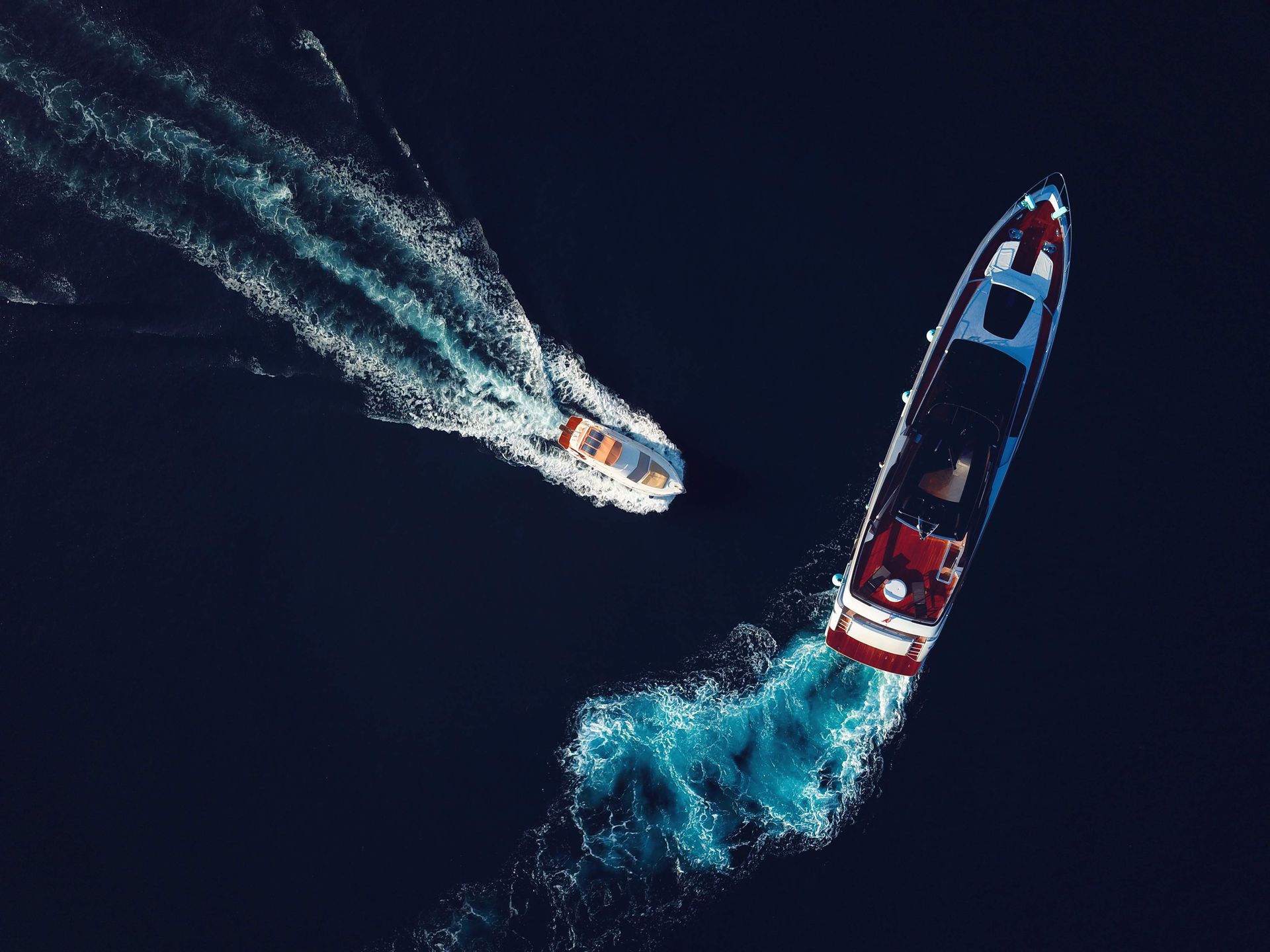Aerial view of two motor yachts crossing each other. Aerial view of two motor yachts crossing each other.