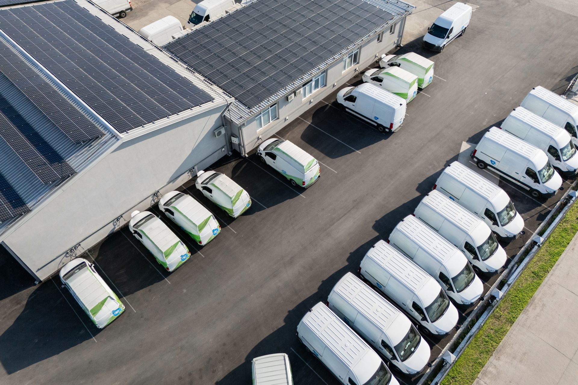 A fleet of commercial service vans parked outside of a business. A fleet of commercial service vans parked outside of a business.