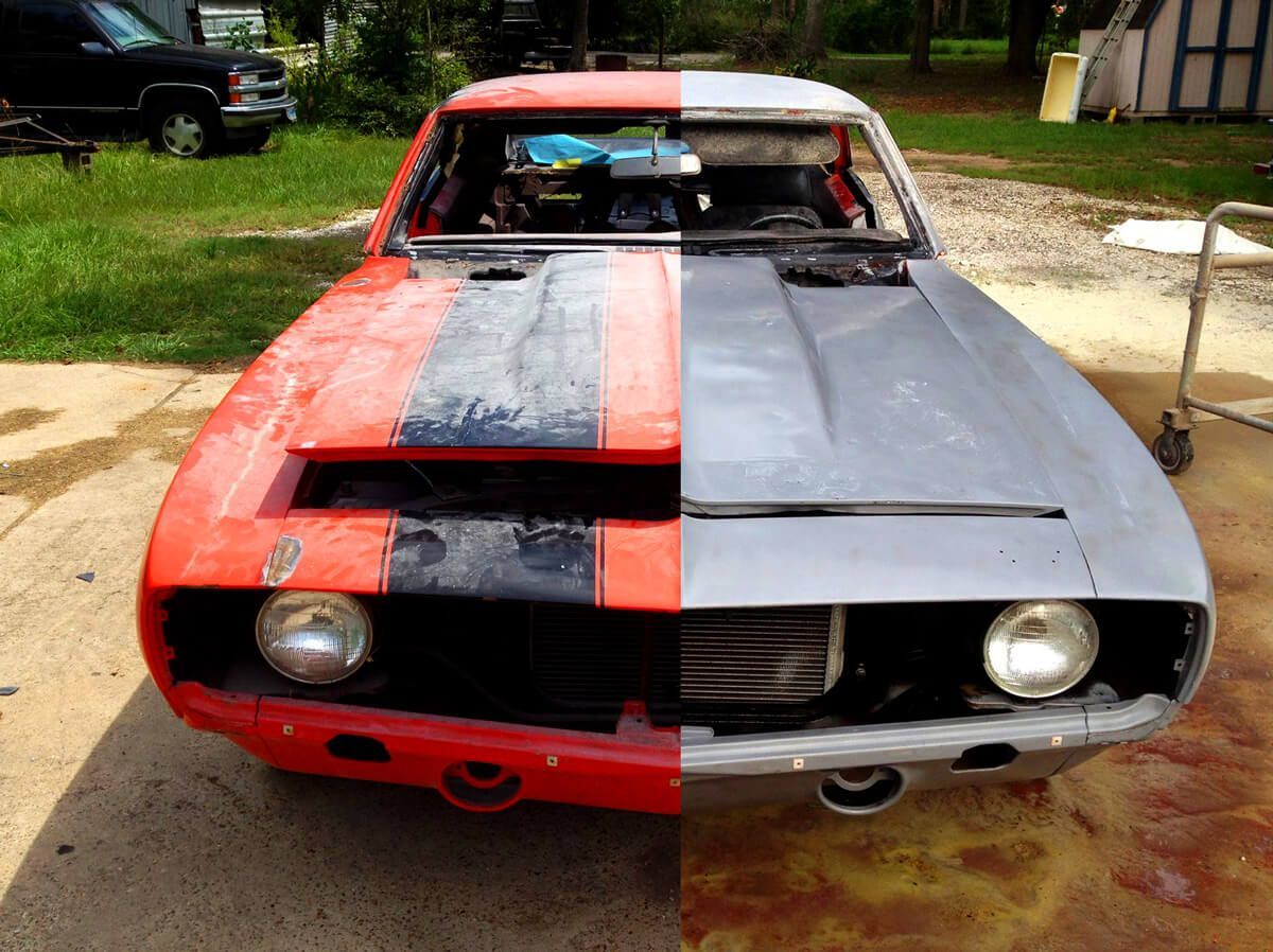 A car that has been painted half red and half gray
