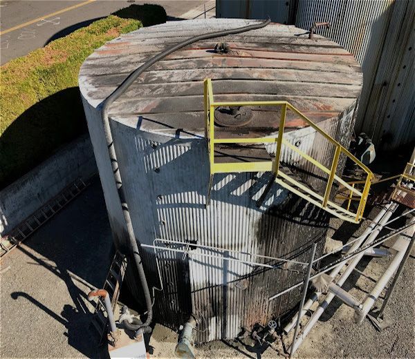 A large metal tank with stairs leading up to it