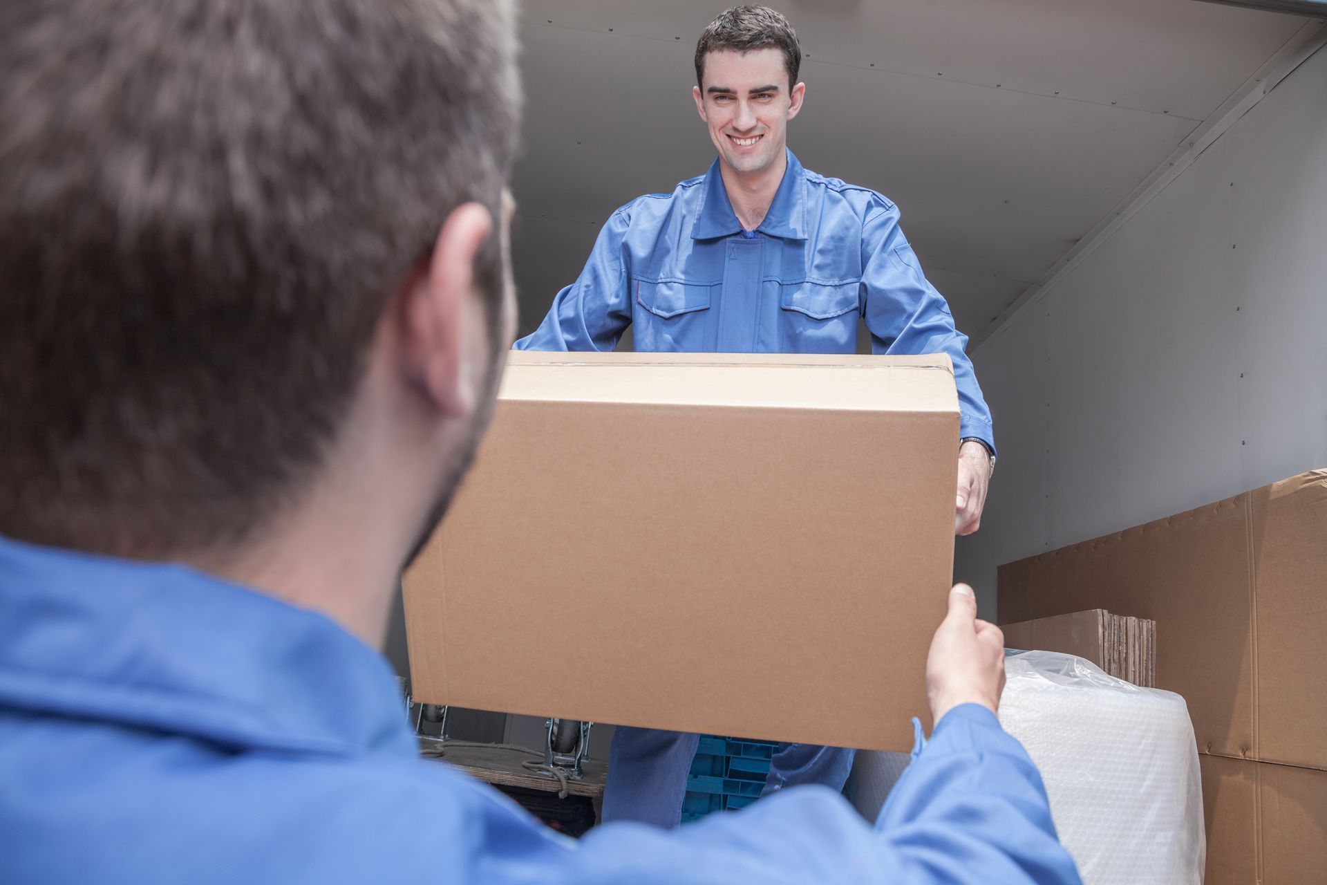 Reliable furniture removal service team happily moving items for customers.