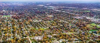 An aerial view of a residential area with lots of trees and houses.